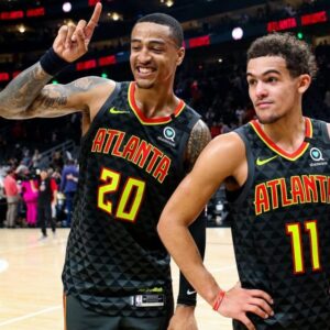 John Collins and Trae Young of the Atlanta Hawks posing for a photo during a post game interview